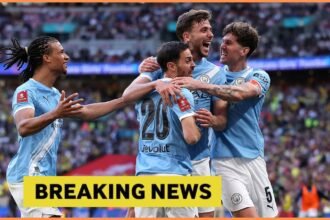 John Stones celebrates with his Man City teammates