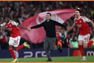 Mikel Arteta celebrating with Arsenal players after beating Atletico Madrid