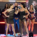 Ronda Rousey and Gina Carano share a stoic showdown, while Nate Diaz and Mike Perry are giving it their all for the match.
