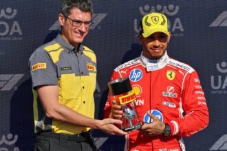 Hamilton is presented with the sprint pole trophy