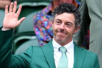 Rory McIlroy wears the green jacket from his Masters victory at Wimbledon