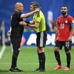 Egypt manager Hossam Hassan arguing with referee and Mo Salah
